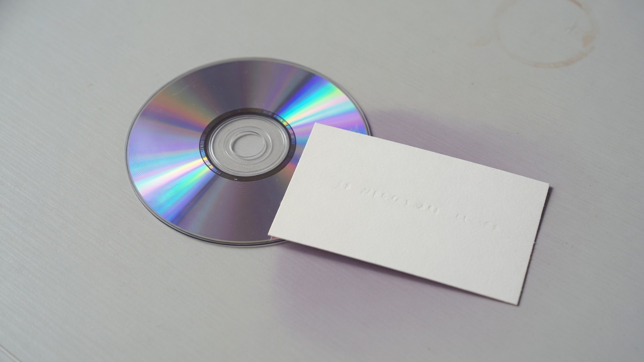 Mini DVD beside a business card